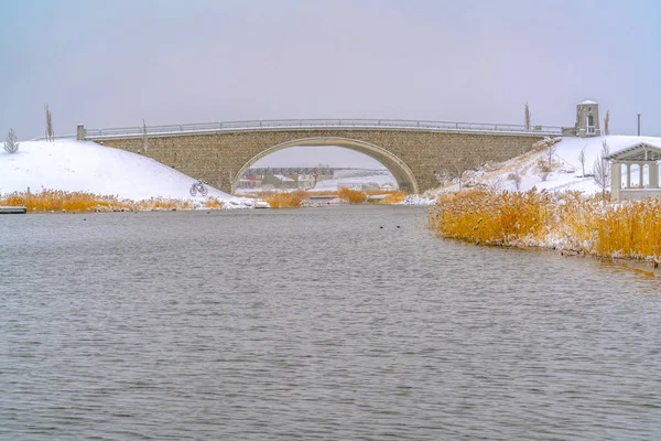 Winter at Oquirrh Lake with bridges and pavilion