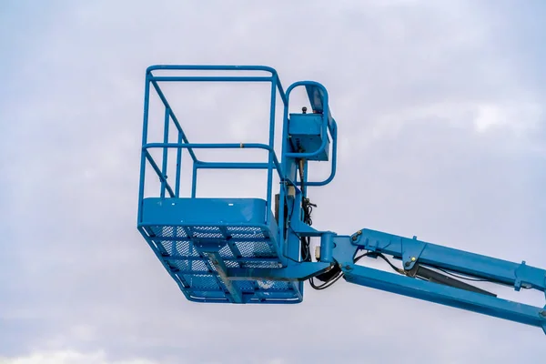 Empty boom lift and cloudy sky in Eagle Mountain