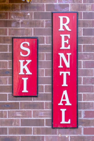 Ski Rental sign isolated against a brick wall