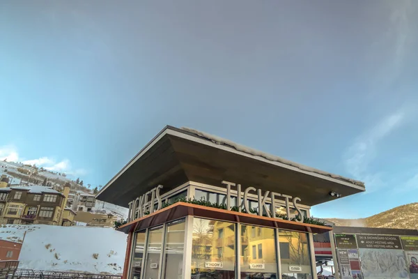 Ticket booth against buildings mountain and sky