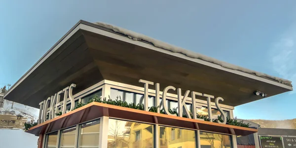 Ticket office with snow covered roof in winter