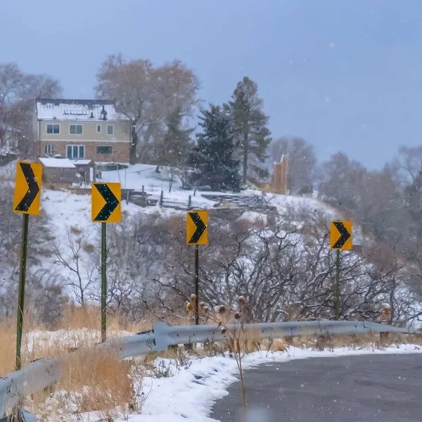 Clear Square Directional road signs against snowy mountain day