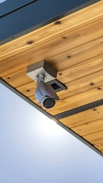 Clear Vertical Home with security camera installed on the wooden underside of its roof
