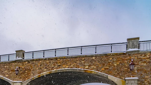 Panorama Arched bridge and snowy trail the lake in Daybreak