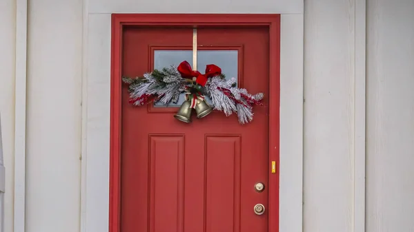 Clear Panorama Front door with glass panel and holiday decoration against a ribbed white wall