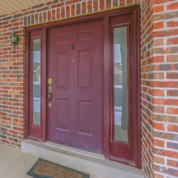 Square Facade of a home with a red front door and reflective sidelights and windows — Stock Photo, Image