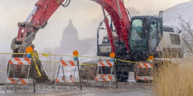 Kışın karlı bir dağ yolunda Panorama Kırmızı ekskavatör ve barikatlar temizleyin