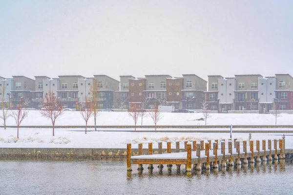 Deck on a lake overlooking buildings in Daybreak