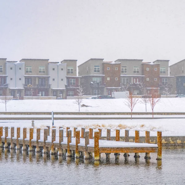 Clear Square Deck on a lake overlooking buildings in Daybreak