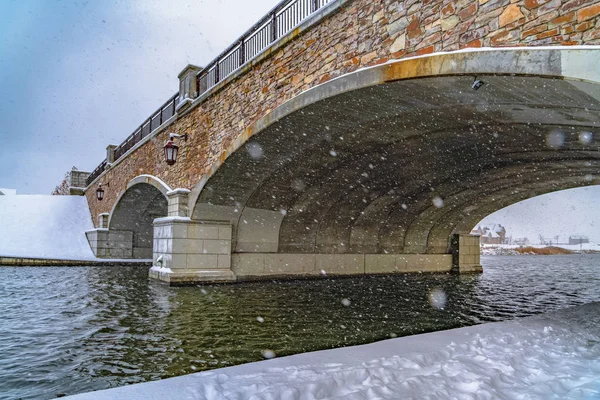 Snowy view under the arched bridge of Oquirrh Lake