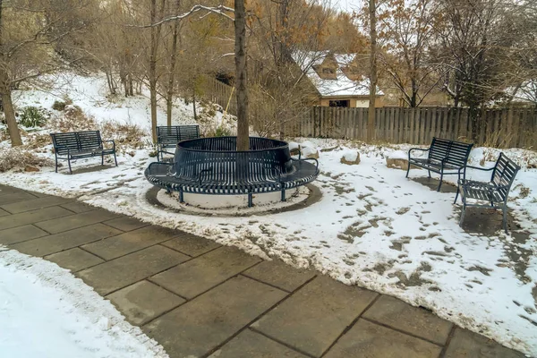 Pathway and metal benches on a hill in Salt Lake City viewed in winter