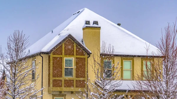 Panorama Winter home with frosty trees on the snow covered front yard in Daybreak Utah