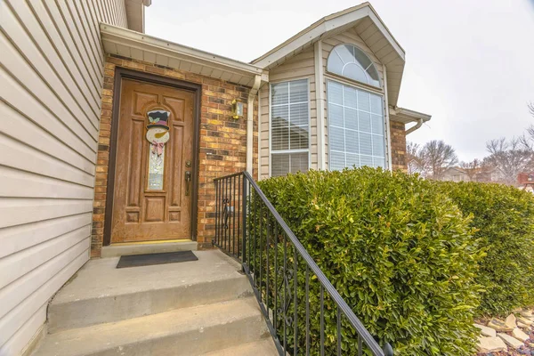 Concrete outdoor stairs leading to the front door with snowman decoration