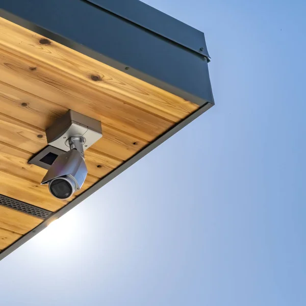 Clear Square Home with security camera installed on the wooden underside of its roof