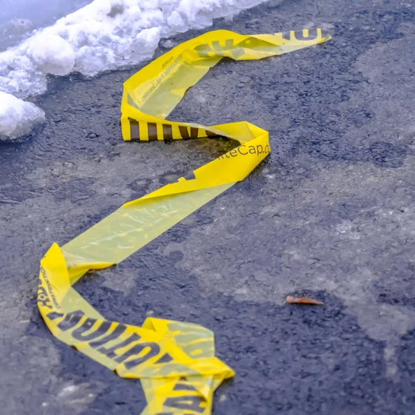 Clear Square Close up of a yellow Caution tape on a road in Eagle Mountain Utah — Stock Photo, Image