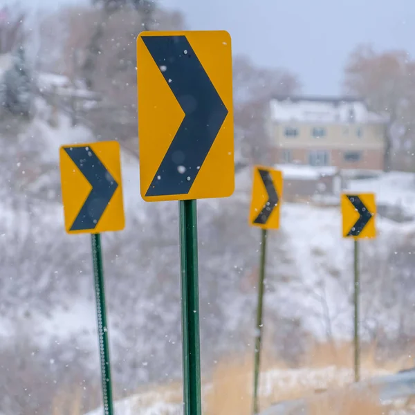 Clear Square Directional road signs against a snowy landscape
