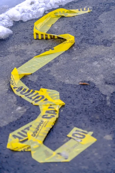 Close up of a yellow Caution tape on a road in Eagle Mountain Utah — Stock Photo, Image