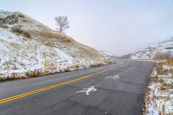 Hill road with pedestrian and bicycle lane sign