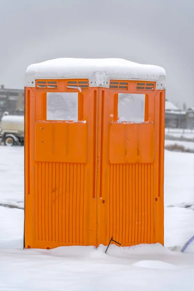 Close up view of a bright orange portable restroom in Daybreak Utah — Stock Image Close up view of a bright orange portable restroom in Daybreak Utah Royalty Free Stock Photos