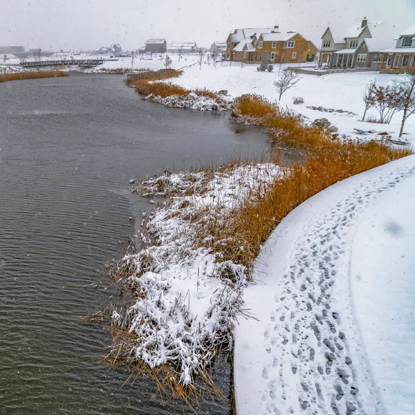 Clear Square Winter lake with track marks on its snowy shore