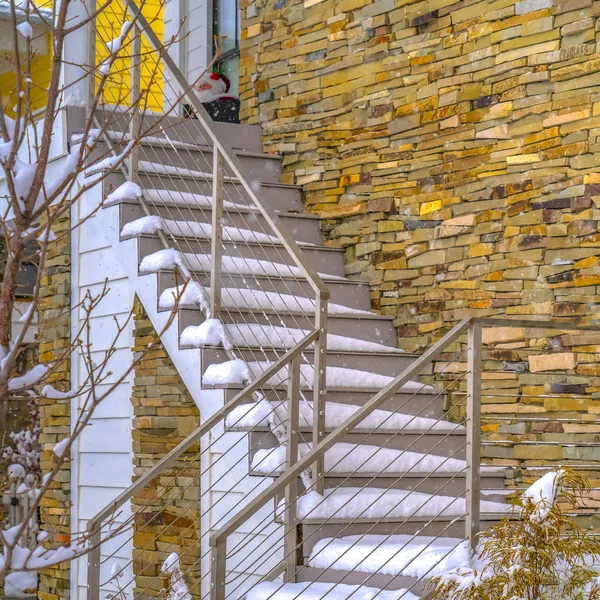 Square Snowy outdoor stairs of home in Daybreak Utah