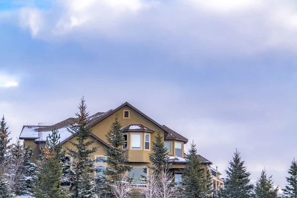 Exterior de uma casa elegante contra o céu azul com nuvens inchadas no inverno — Fotografia de Stock