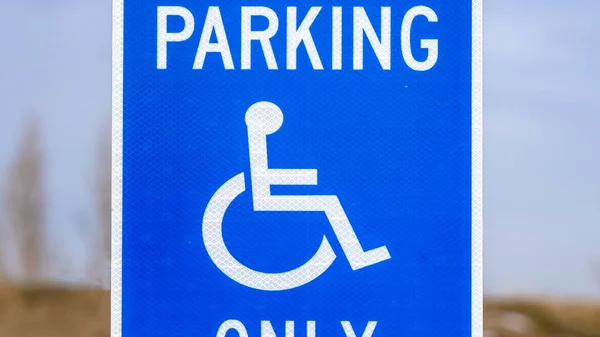 Panorama Blue Reserved Parking Van Accessible sign with a man on a wheelchair icon