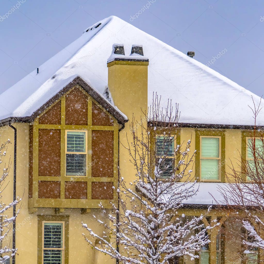 Beautiful house in Daybreak Utah with a snow covered roof against blue sky