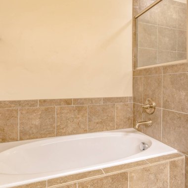 Kare çerçeve Pırıl pırıl beyaz küvet inşa ile sıcak tonda banyo Iç