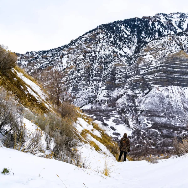 Квадратный Человек с видом на величественную гору, покрытую порошком — стоковое фото