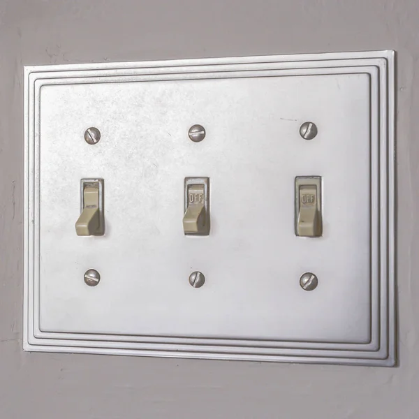 Quadrado Fechar o interruptor de luz elétrica contra o branco — Fotografia de Stock
