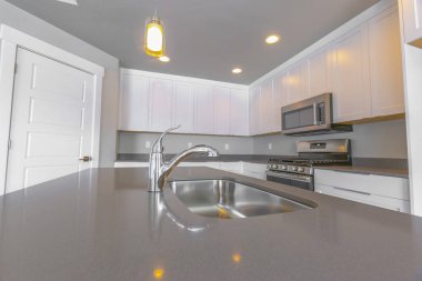 Modern mutfak içinde musluk ve lavabo ile parlak tezgah