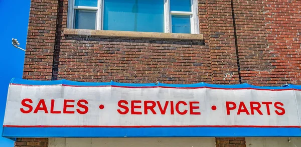 A huge sign that reads Sales Service Parts outside a commercial — Stock Photo, Image