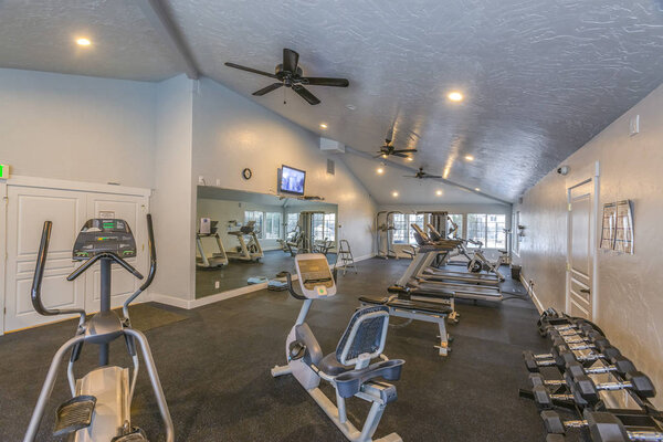 Interior of a spacious fitness gym with various exercise equipment