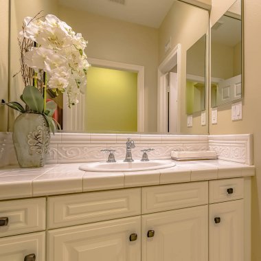 Frame Square Interior of a small bathroom with a single sink vanity area and toilet clipart