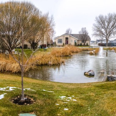 Kare Kare Küçük gölet ortasında bir çeşme ile karla kaplı çim çevrili
