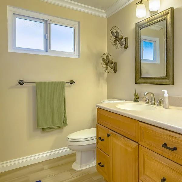 Square Double vanity with wooden cabinets inside a bathroom with small window — Stock Photo, Image