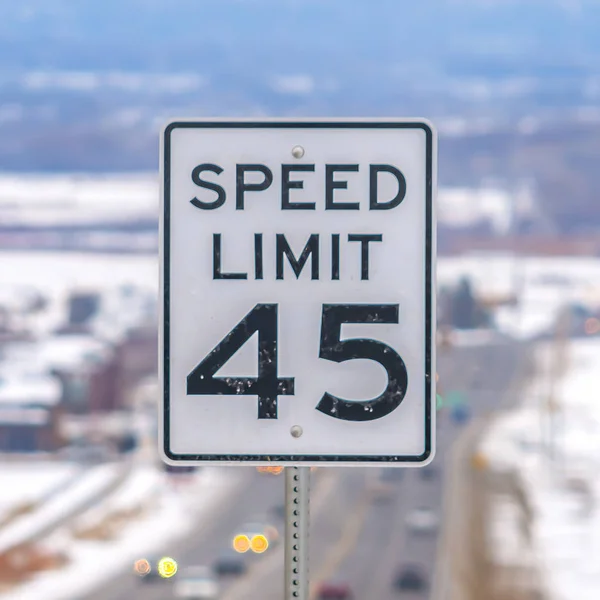 Frame Square Cierre de una señal de límite de velocidad en una carretera rodeada de nieve en invierno — Foto de Stock