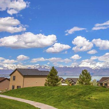 Square Pathway bir gölün önünde evlere giden geniş bir çimenli arazi üzerinde