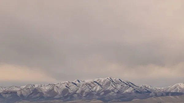 Panorama eines majestätischen Berges mit schroffen, schneebedeckten Gipfeln — Stockfoto