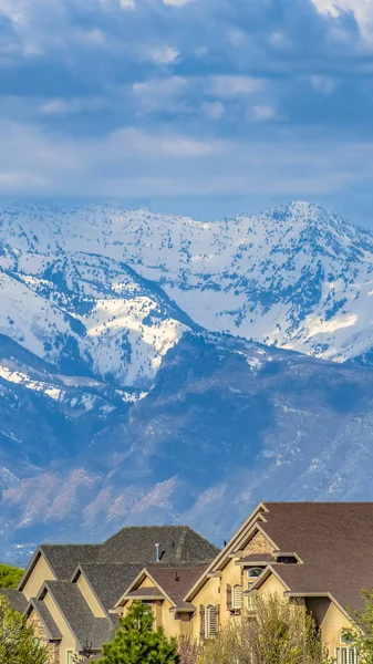Panorama Casas y exuberantes árboles verdes con la montaña nevada en el fondo —  Fotos de Stock