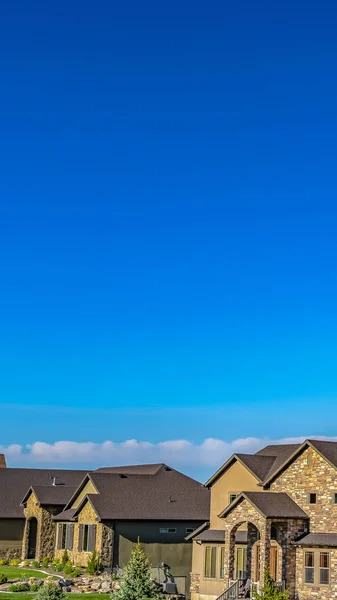 Panorama Fachada de casas elegantes con césped bellamente ajardinado visto en un día soleado — Foto de Stock