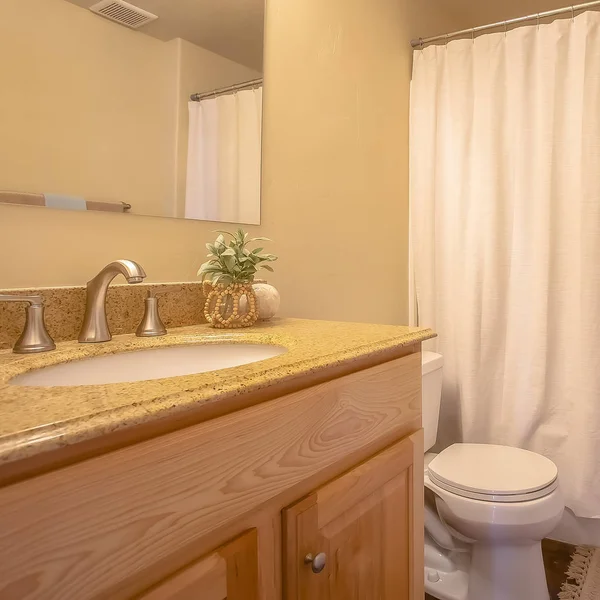 Quadro quadrado Toliet e área de vaidade dentro de um banheiro com haste de toalha e espelho na parede — Fotografia de Stock
