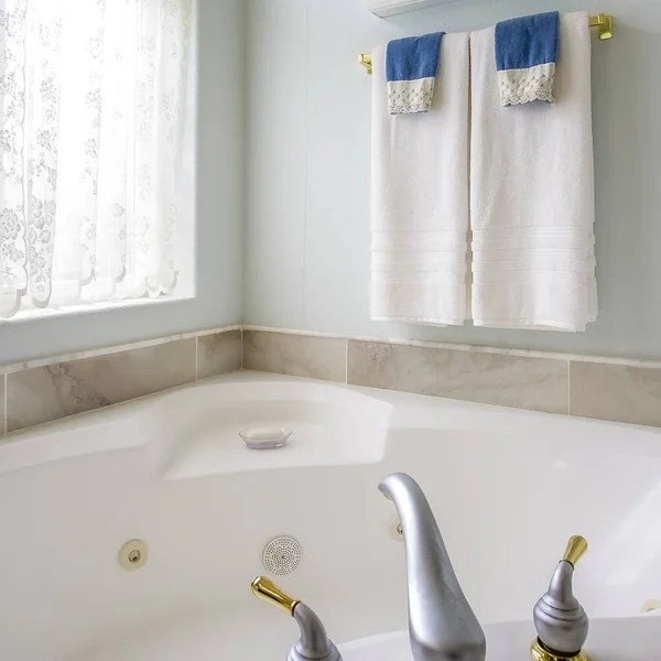 Quadrato Interno del bagno con vasca da bagno scintillante accanto a una grande finestra ad arco — Foto Stock