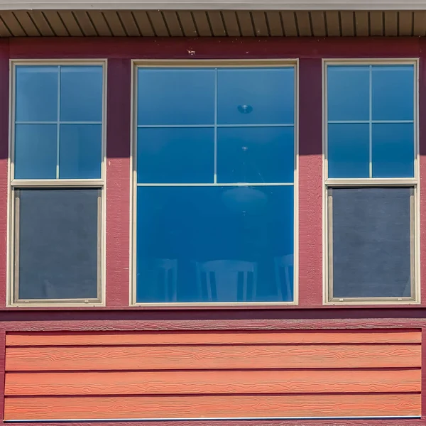 Square Window of a home with combination of wood section and neutral exterior wall