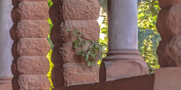 Stone pillars with trees in the background