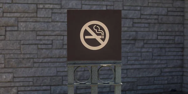 No smoking sign against a gray brick wall