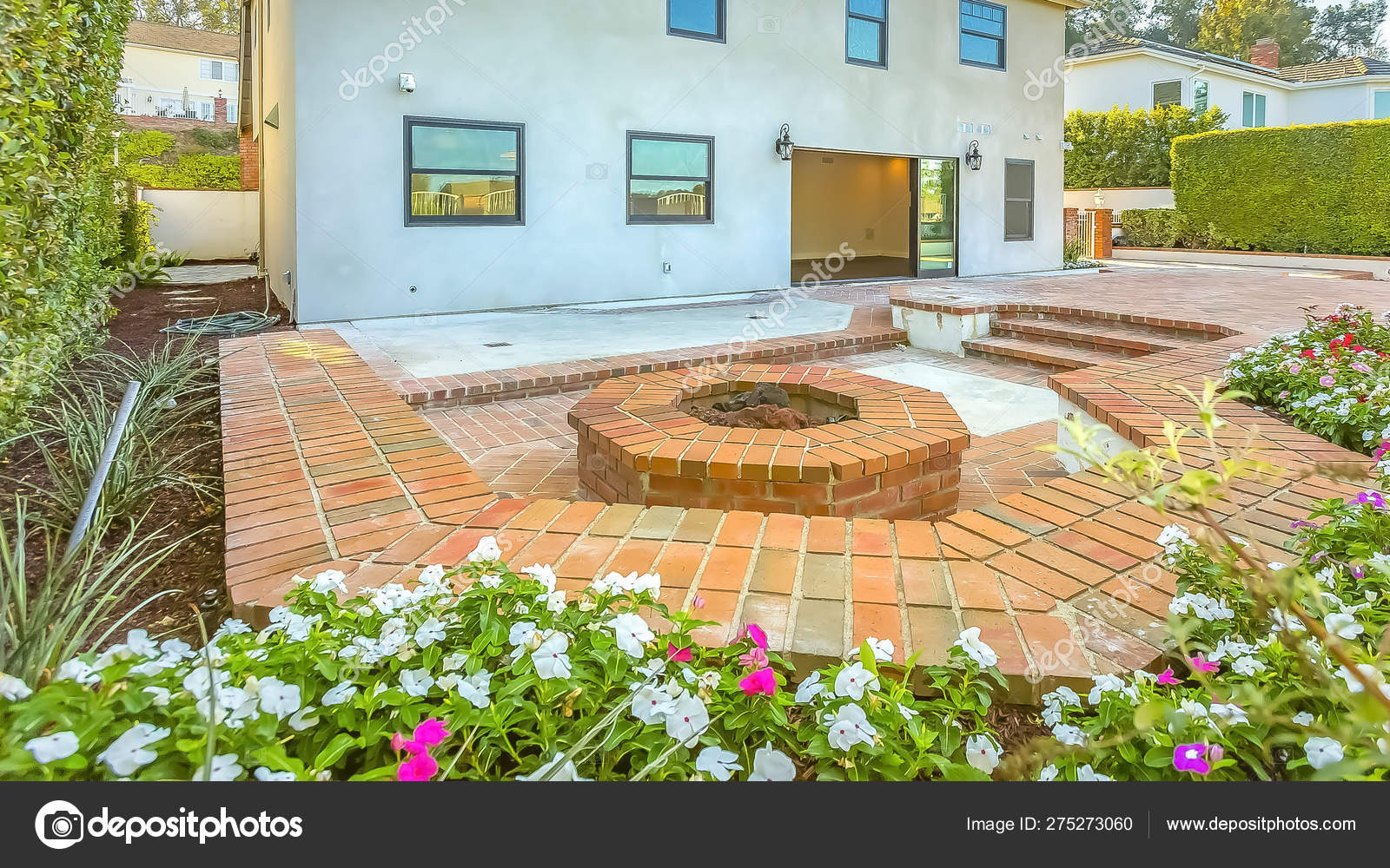 Panorama House With A Stone Brick Patio And Octagonal Fire Pit