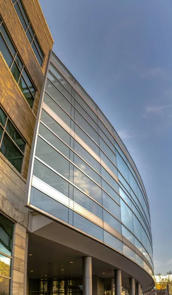 Exterior de um edifício moderno visto de baixo com fundo azul céu — Fotografia de Stock