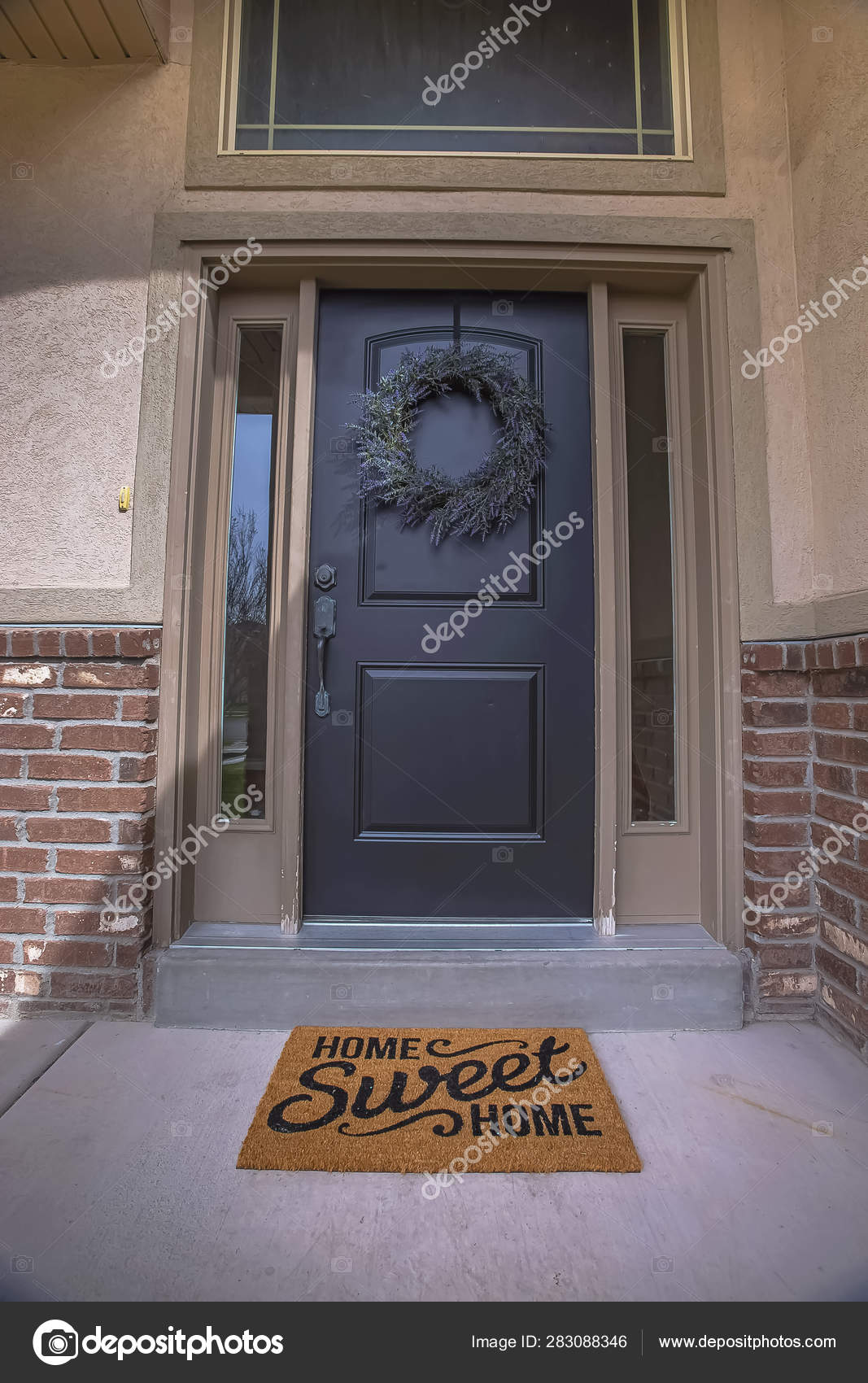 Wreath And Doormat On The Front Door With Sidelights And Transom
